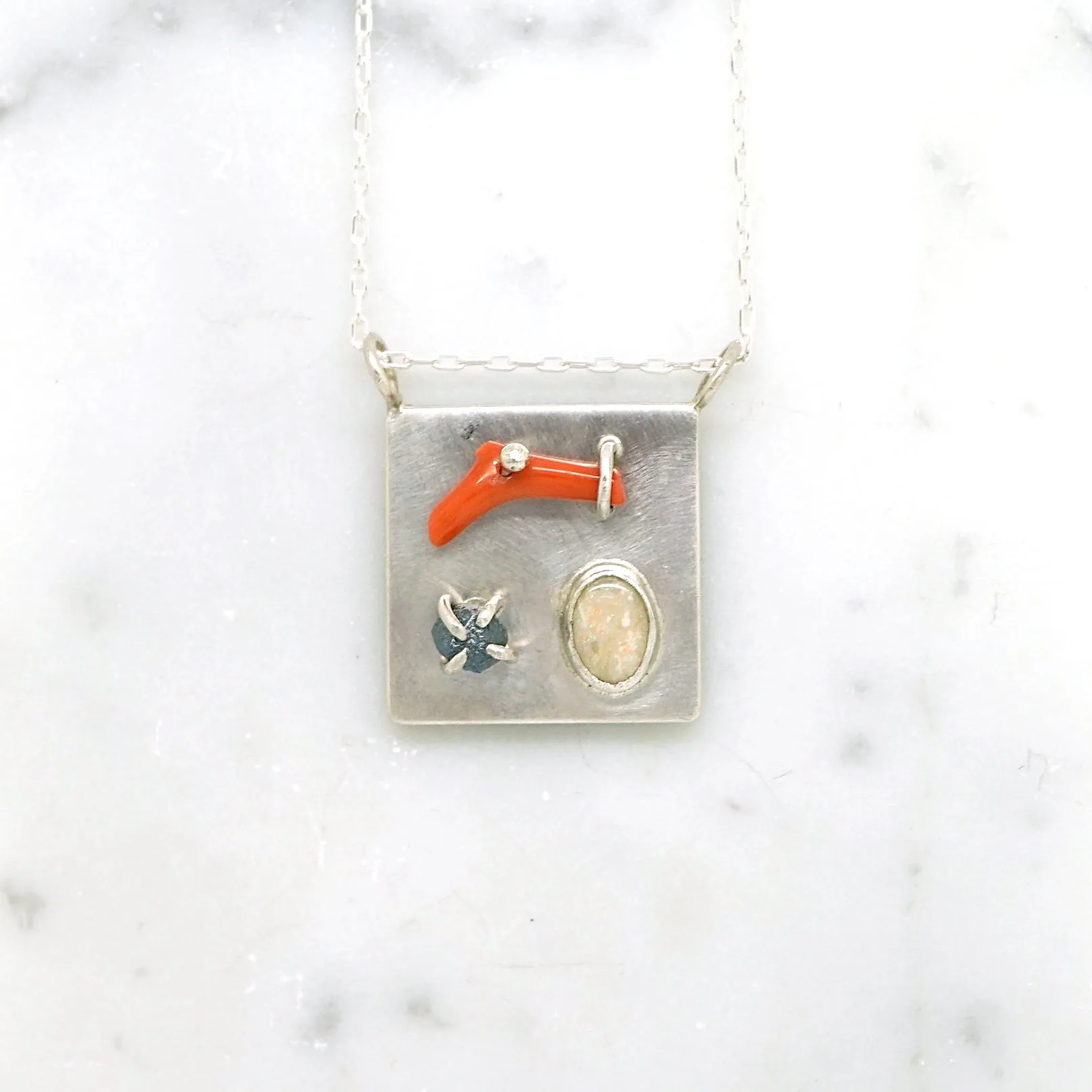 Art pendant necklace with coral, opal, and raw diamond