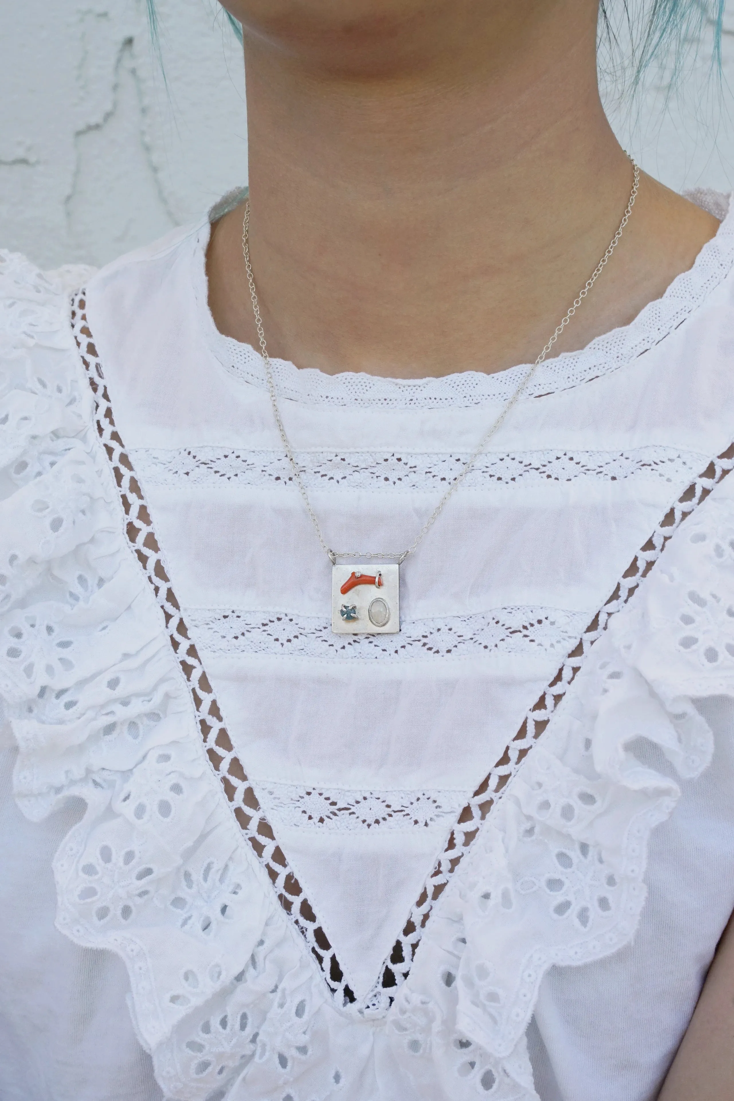 Art pendant necklace with coral, opal, and raw diamond