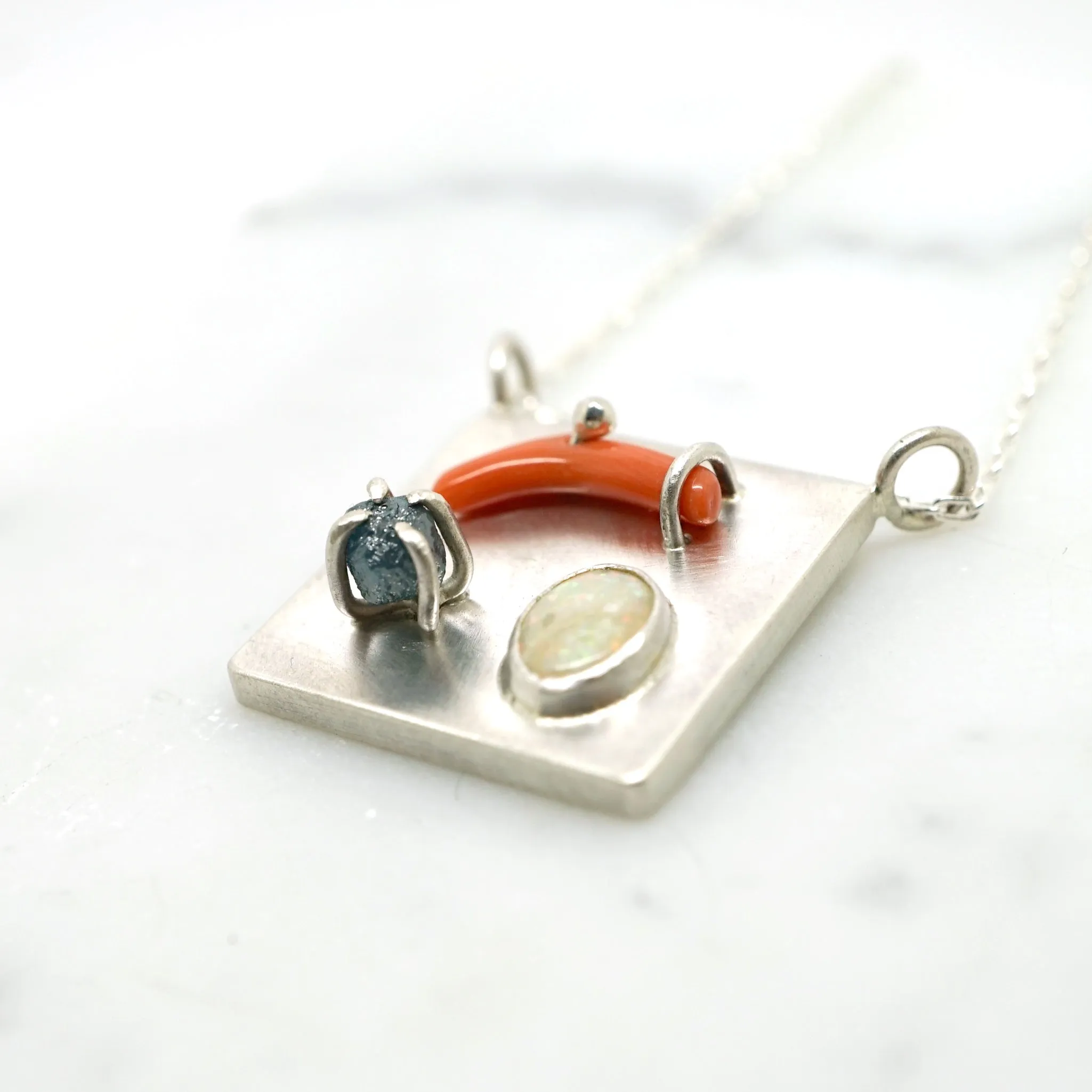 Art pendant necklace with coral, opal, and raw diamond
