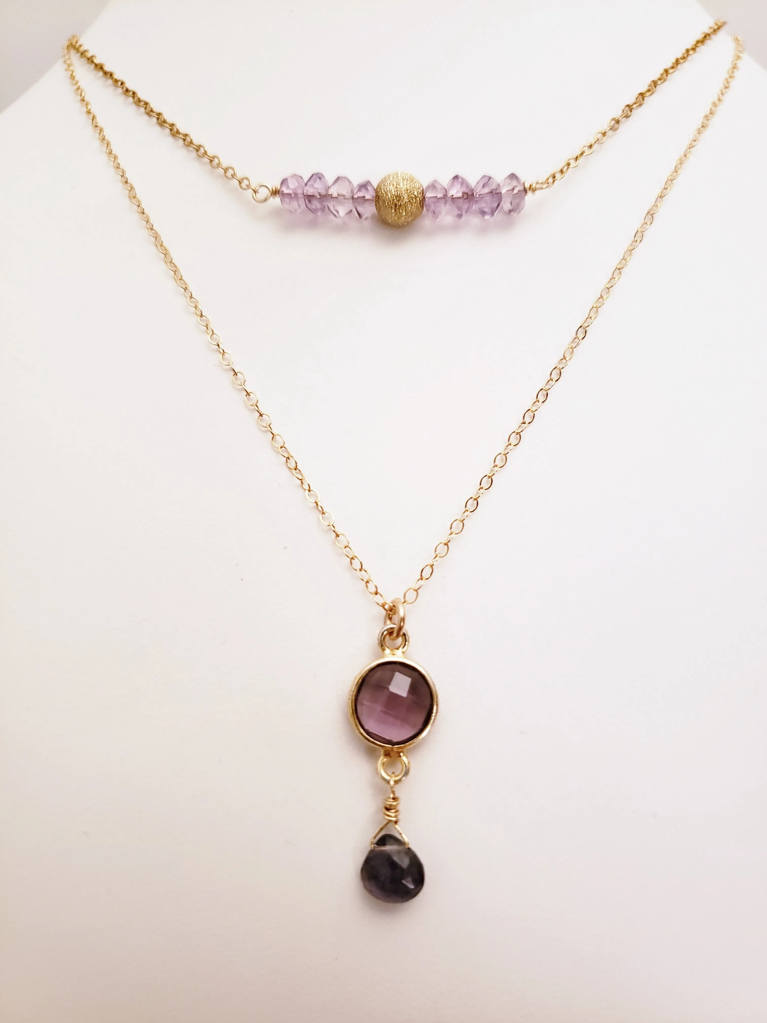 Delicate Pendant Necklace Features a Faceted Bezel Set Amethyst With a Faceted Iolite Tear Drop on a Fine Gold-Filled Chain.