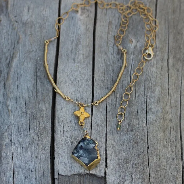 Gold-rimmed druzy stone pendant necklace with brass flower and branches