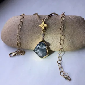 Gold-rimmed druzy stone pendant necklace with brass flower and branches
