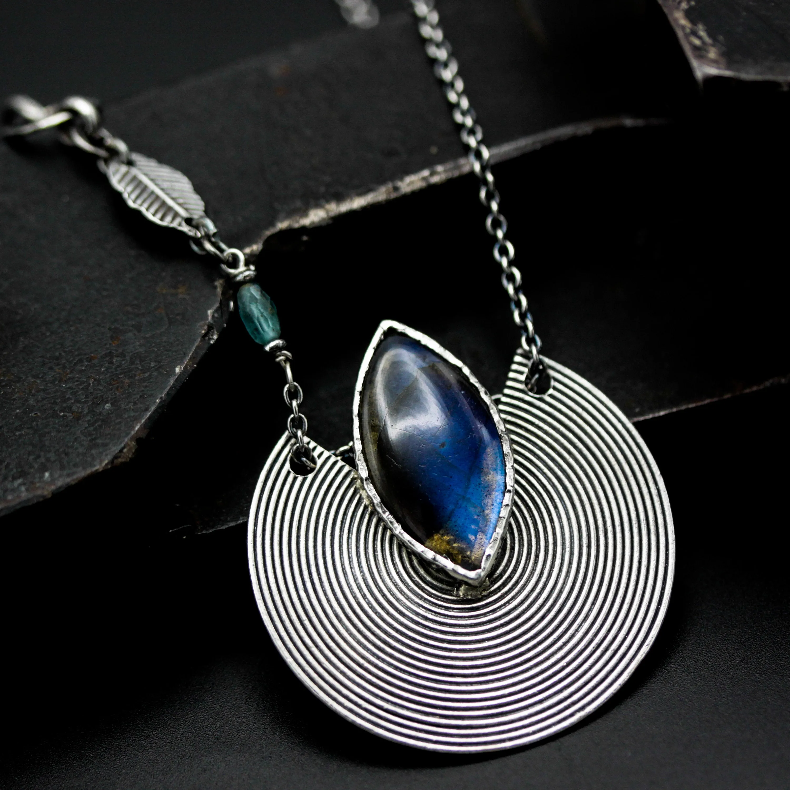 Marqiuse cabochon labradorite pendant necklace with silver circle in spiral design on sterling silver chain