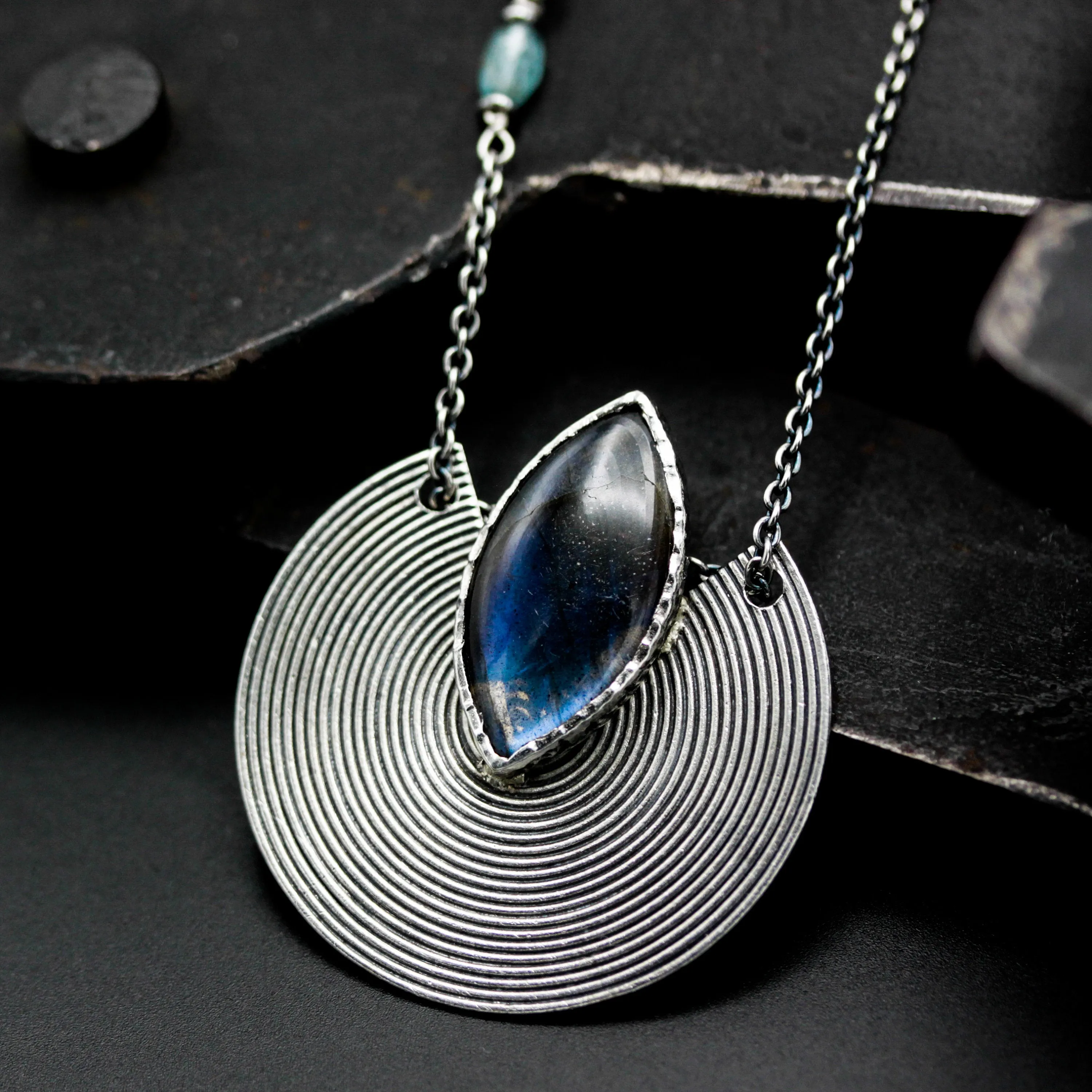 Marqiuse cabochon labradorite pendant necklace with silver circle in spiral design on sterling silver chain