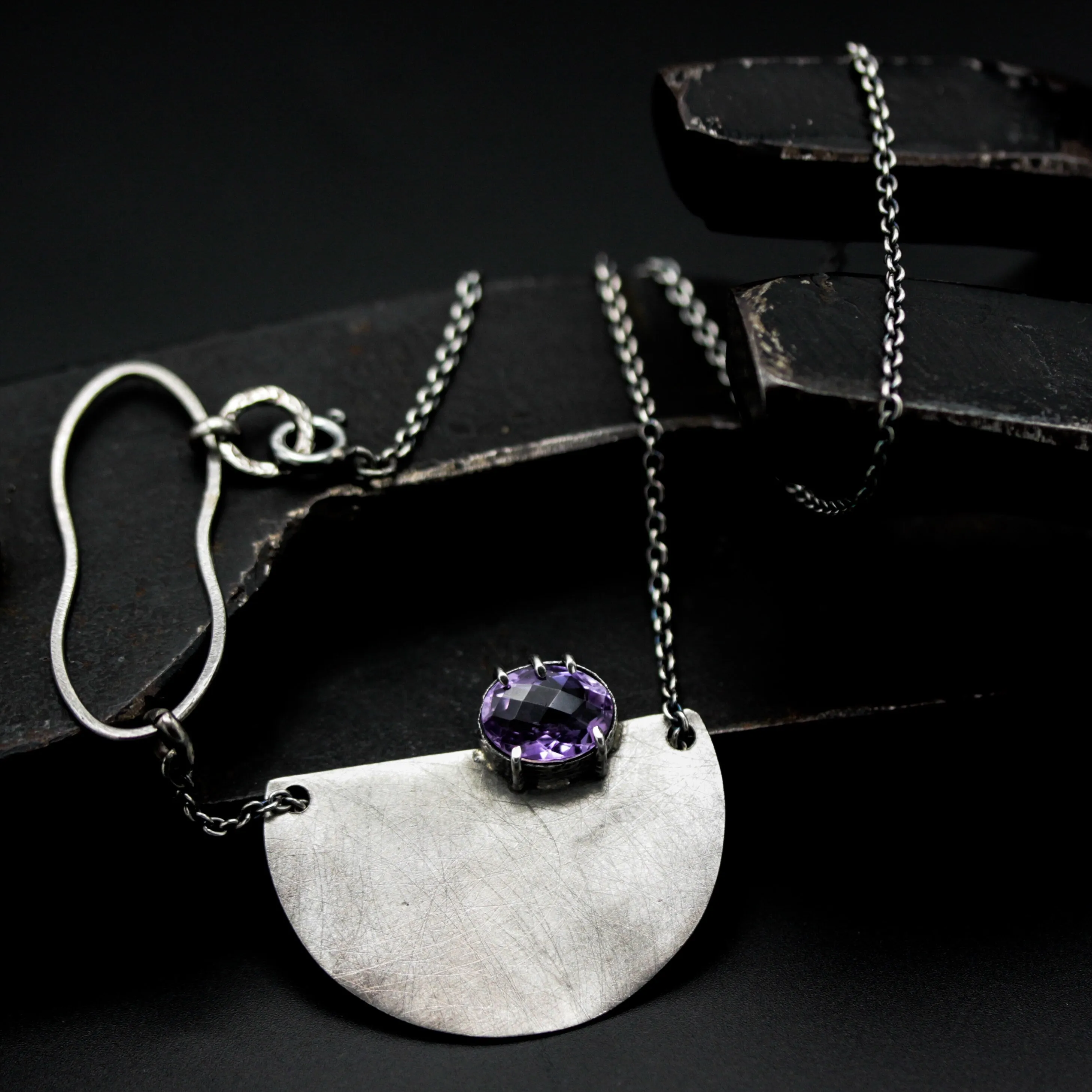 Oval Amethyst pendant necklace in silver bezel and prongs setting with silver semi-circle shape on sterling silver chain