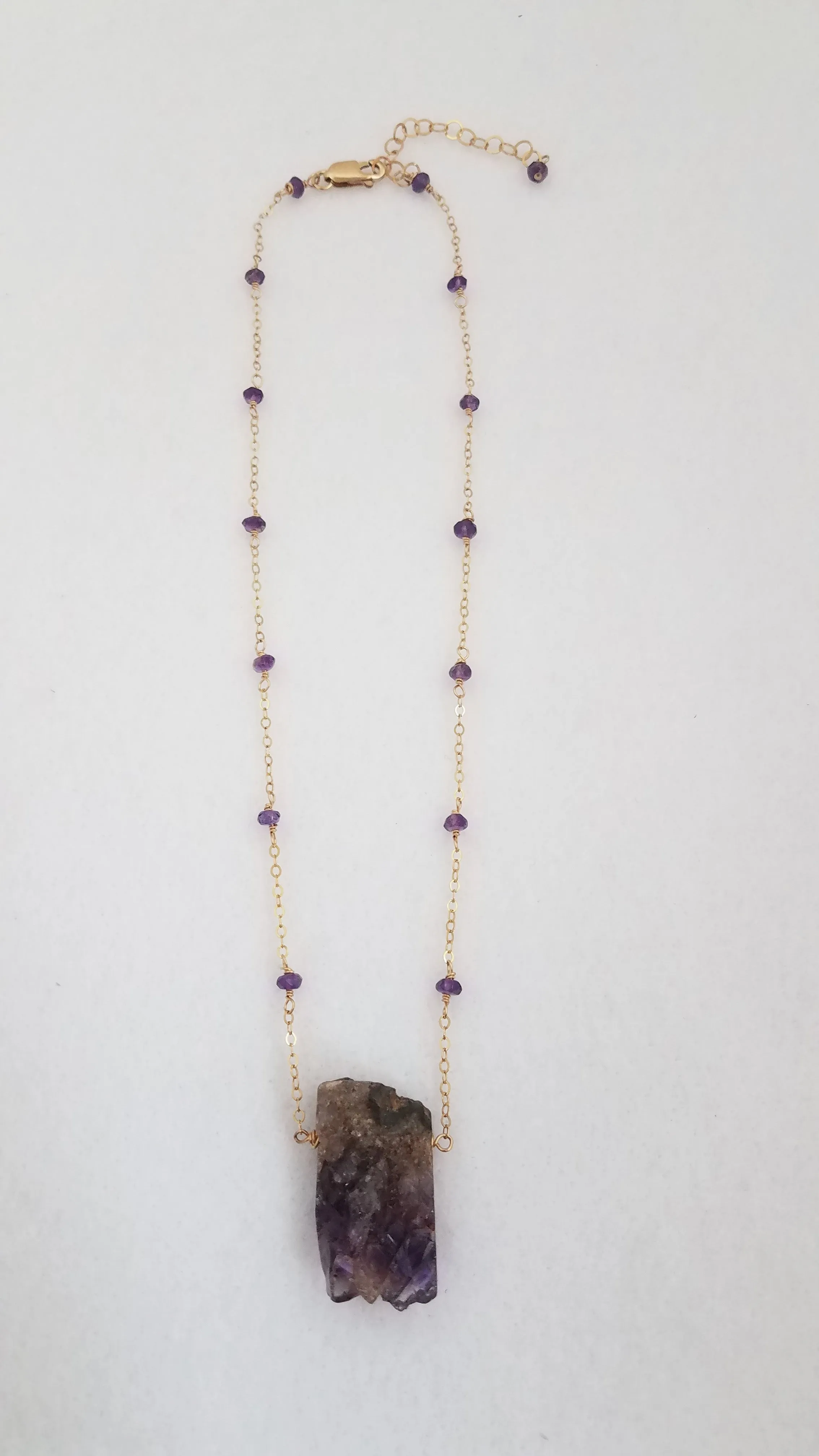 Raw Amethyst Nugget Pendant is Surrounded by Faceted Amethyst roundel on Gold-Filled Chain.