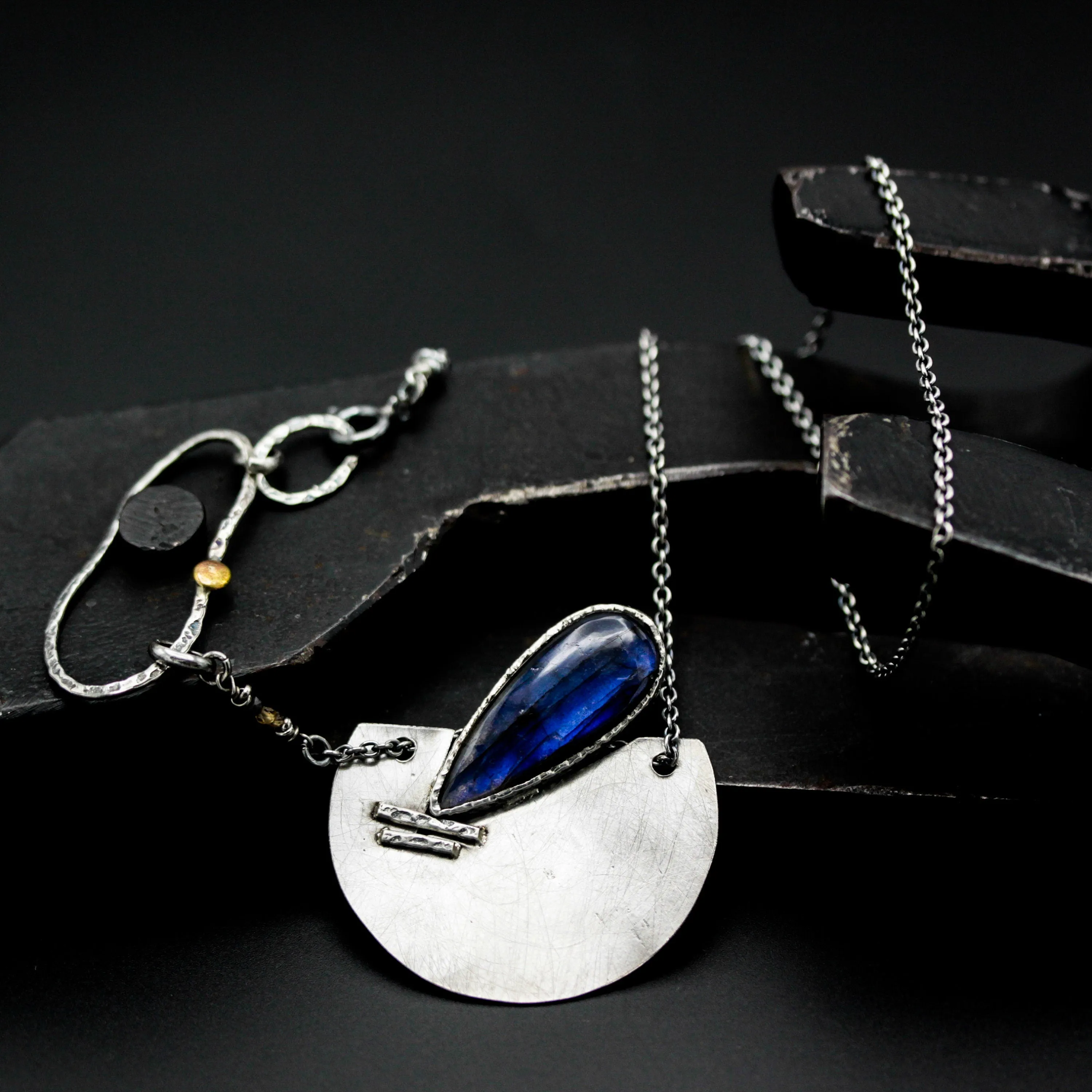 Teardrop Labradorite pendant necklace with silver semi-circle in matte finish brush texture on sterling silver chain