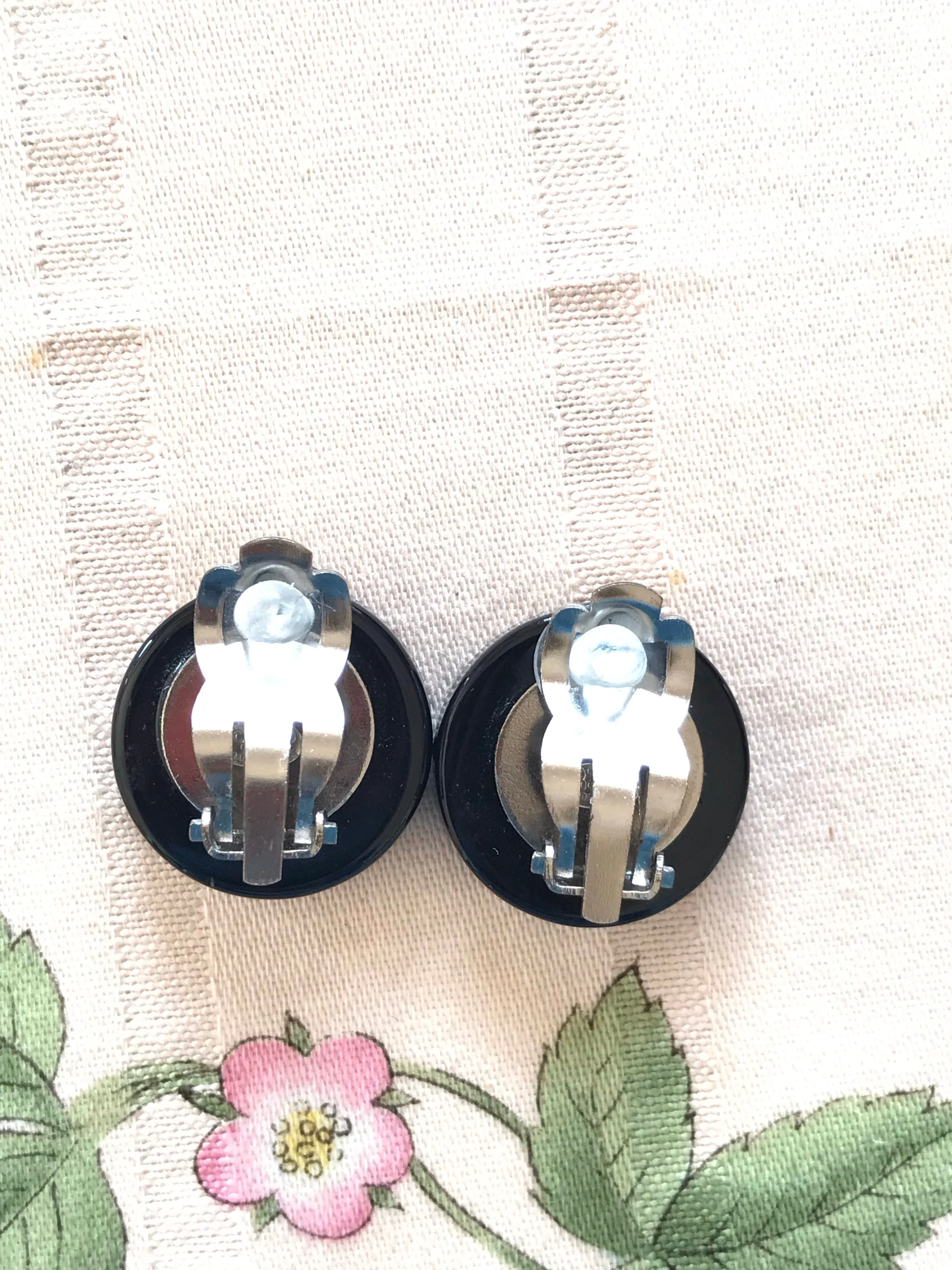 Vintage Chanel round earrings with silver and black mod design.