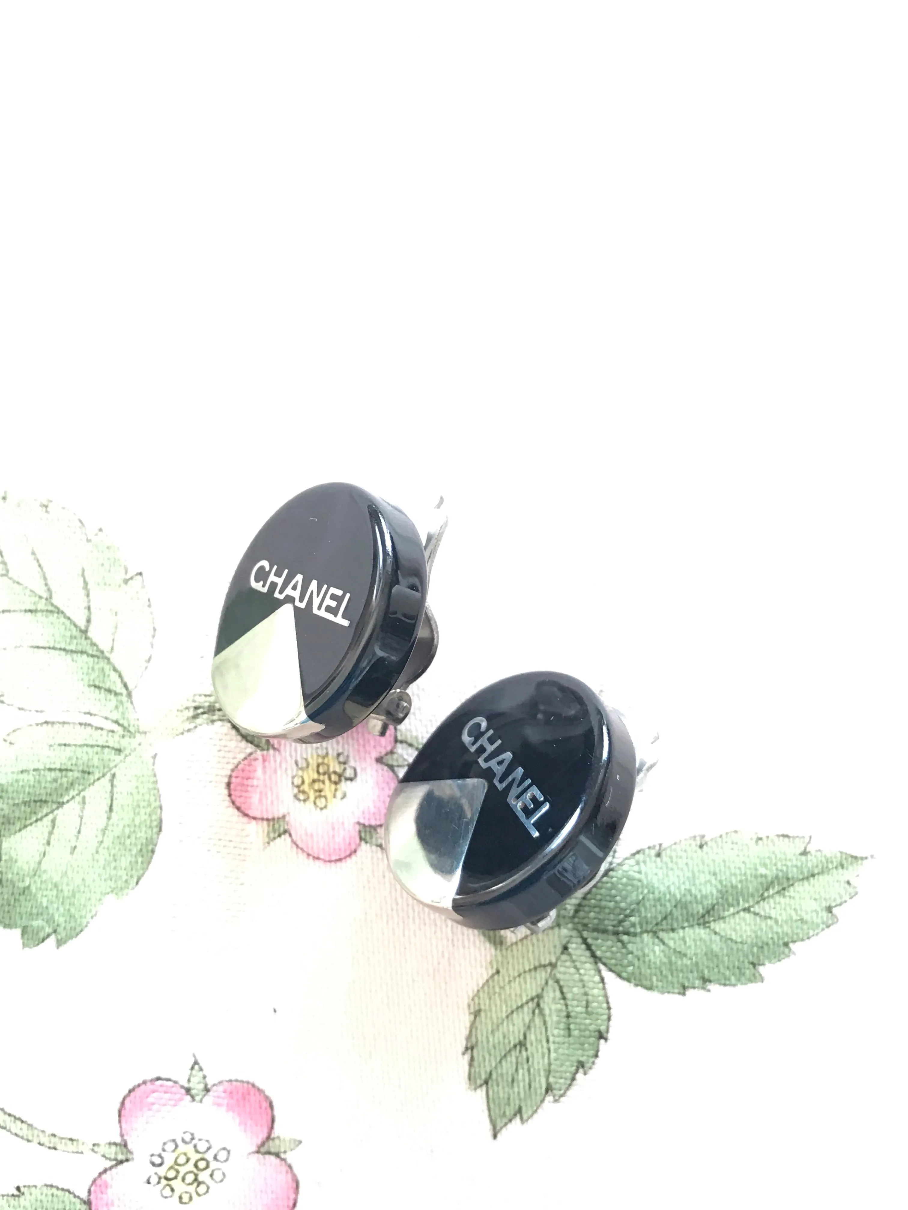 Vintage Chanel round earrings with silver and black mod design.