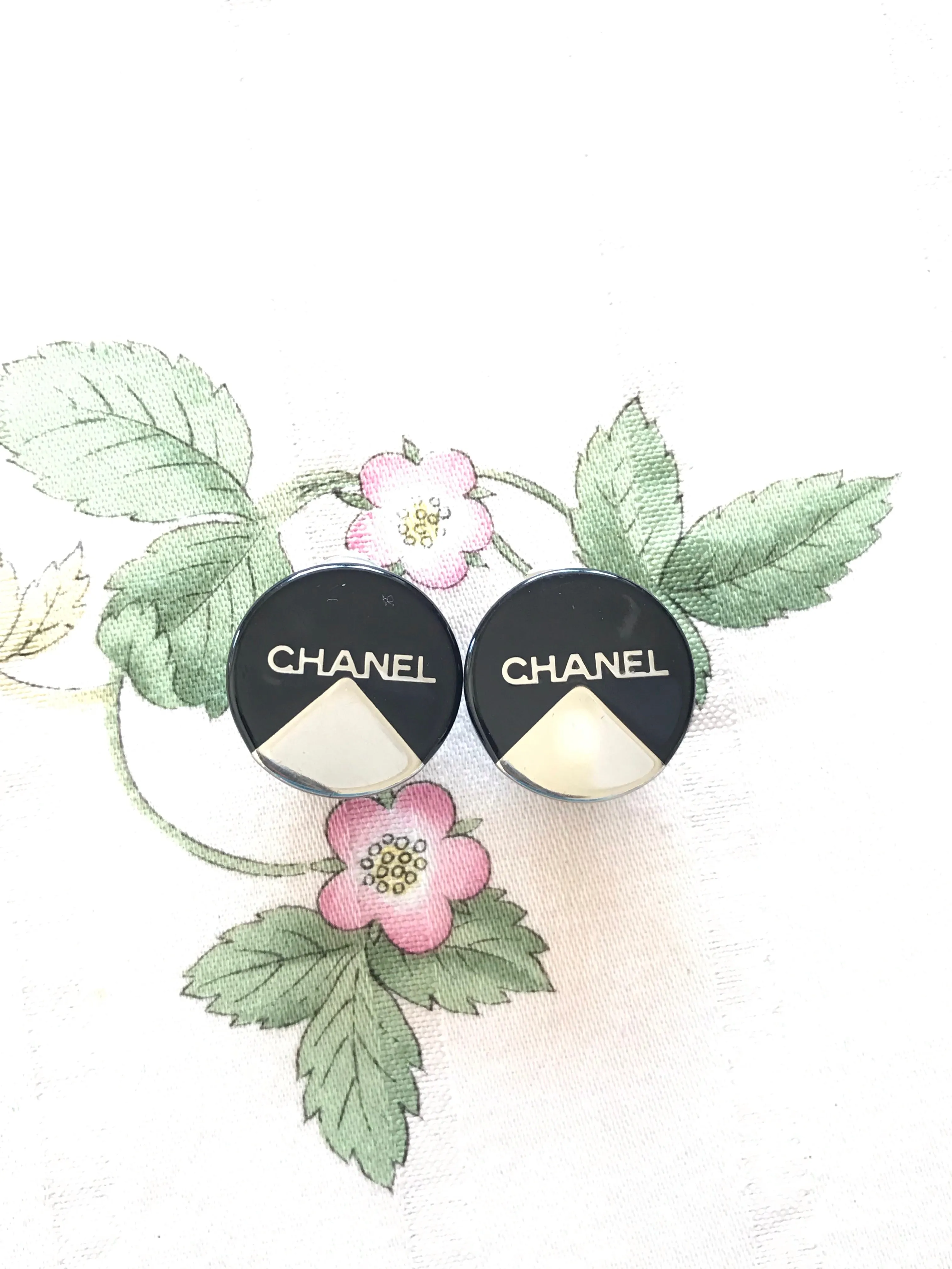Vintage Chanel round earrings with silver and black mod design.