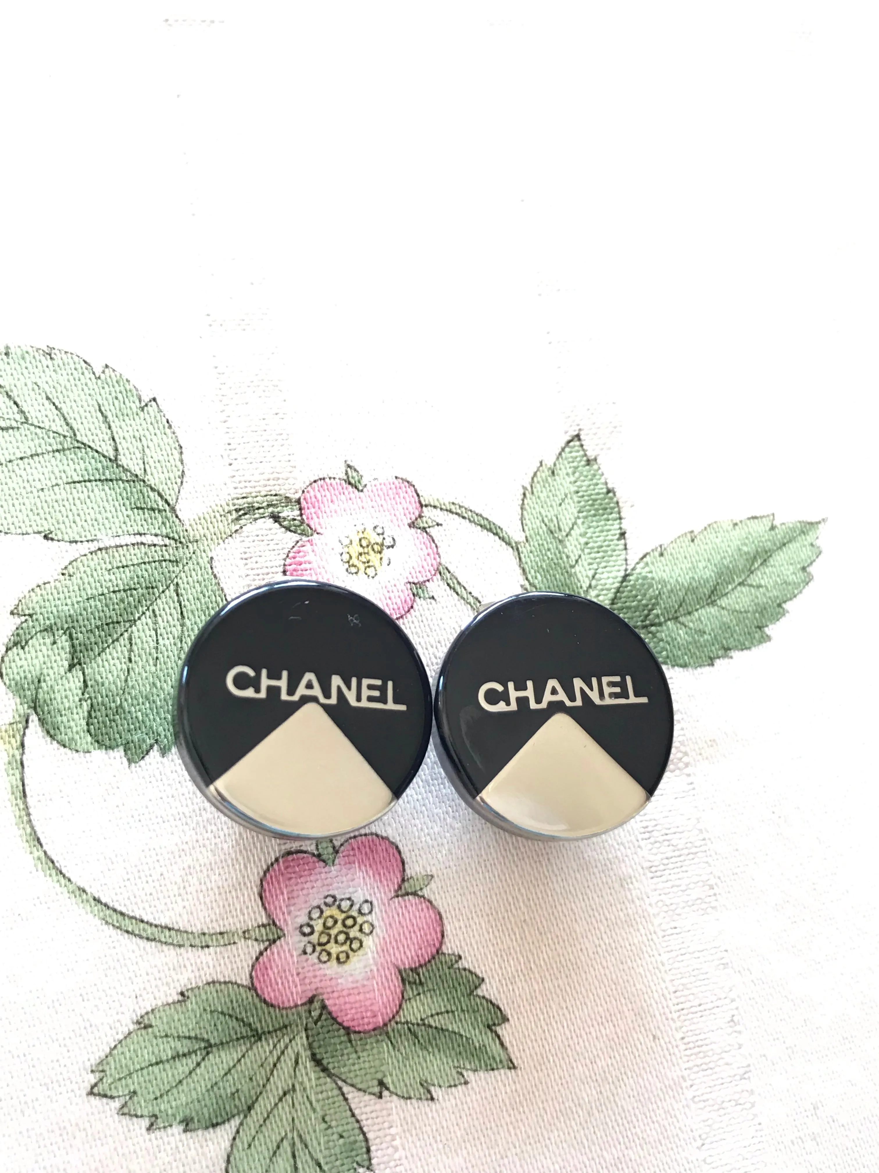 Vintage Chanel round earrings with silver and black mod design.
